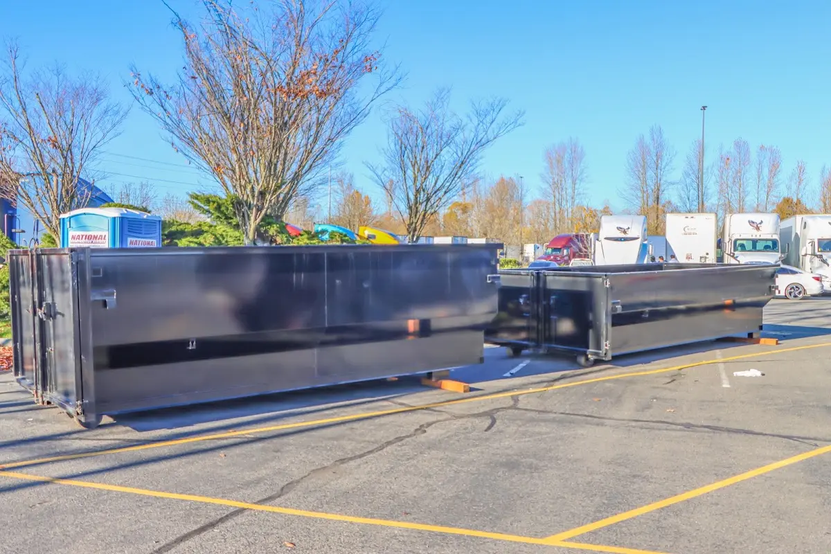 Professional dumpster rental service with roll-off container on residential driveway in North Valley